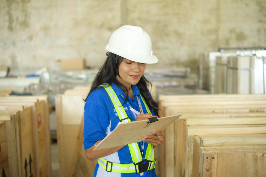 Logistics staff reviewing export documents on a clipboard